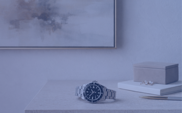 High value items like art & watch on a table - Verlingue UK