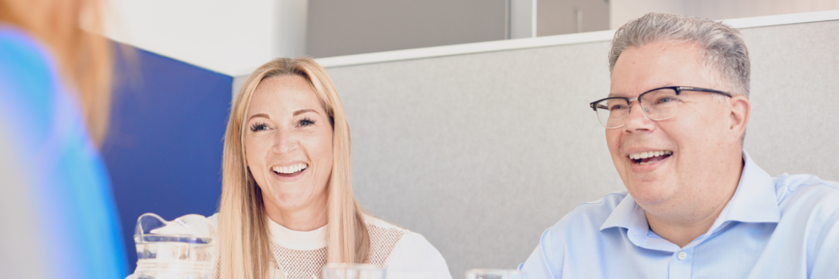 Colleagues laughing in a meeting